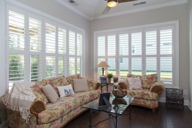 Airy sunroom with plantation shutters in Houston.